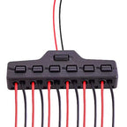 Black electrical connector with red and black wires on a white background
